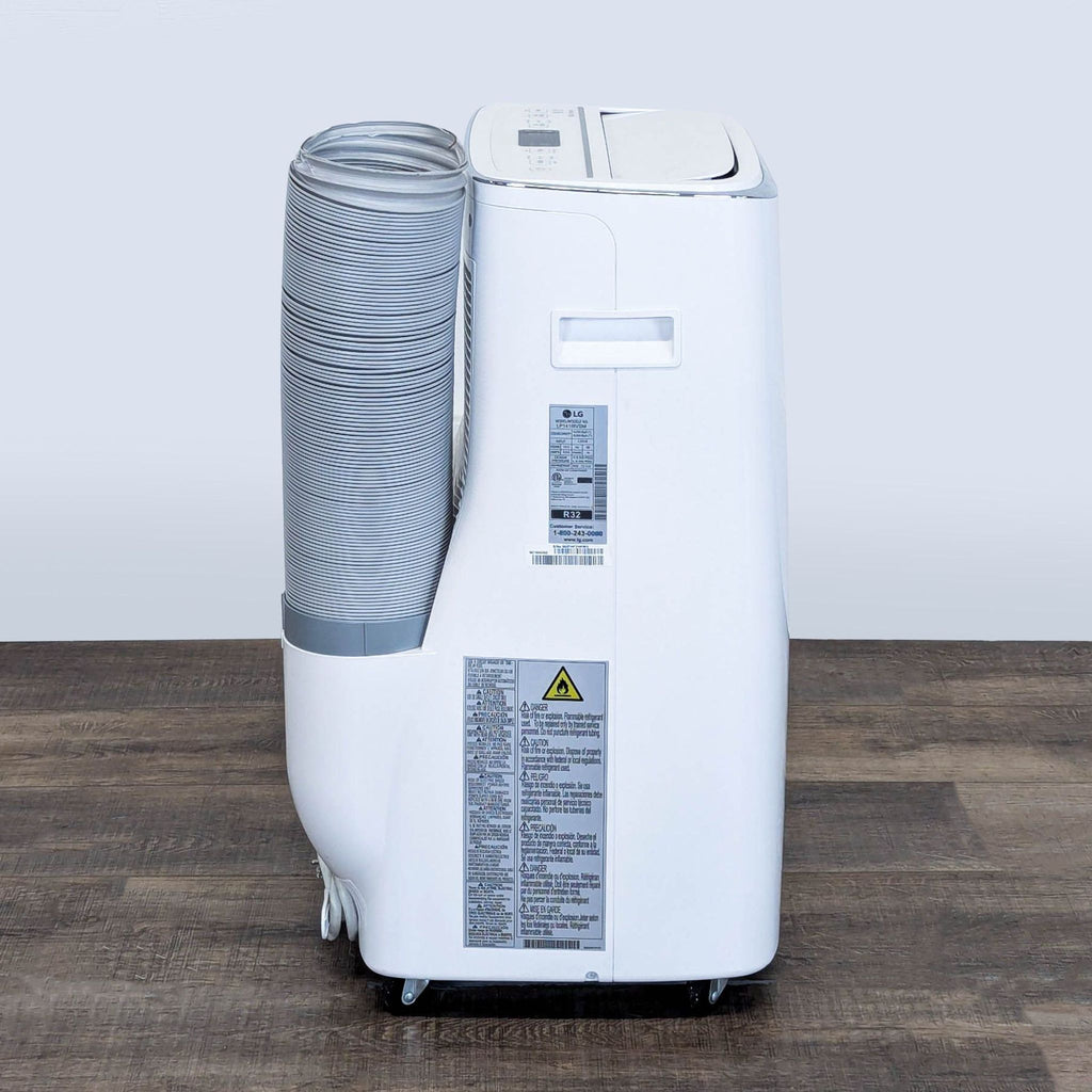 2. Side view of LG portable AC showing control panel, labels, carry handle, and detachable exhaust hose.