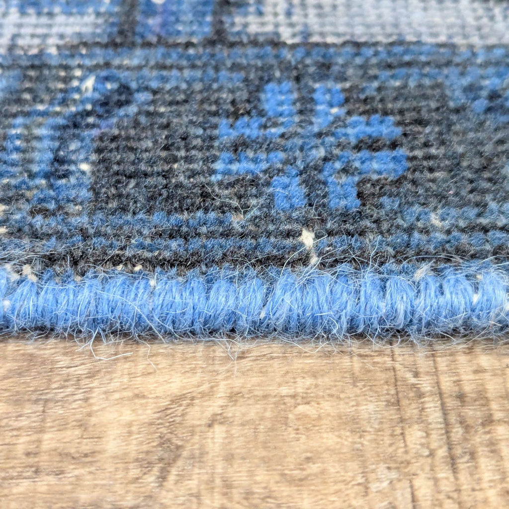 3. Macro shot of the edge detailing and wool texture on a vintage over dyed Reperch area rug.