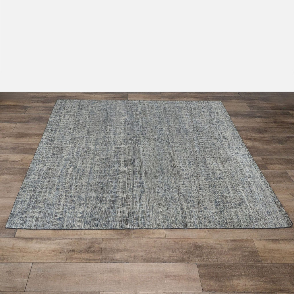1. Grey and blue hand-knotted Reperch wool area rug displayed on wood flooring.