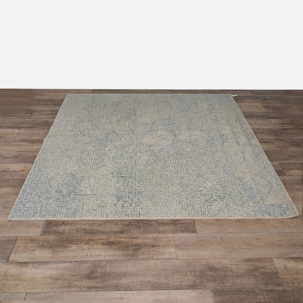 1. Hand-hooked Crate & Barrel rug with a light blue maze motif, shown laid flat on wood flooring.  