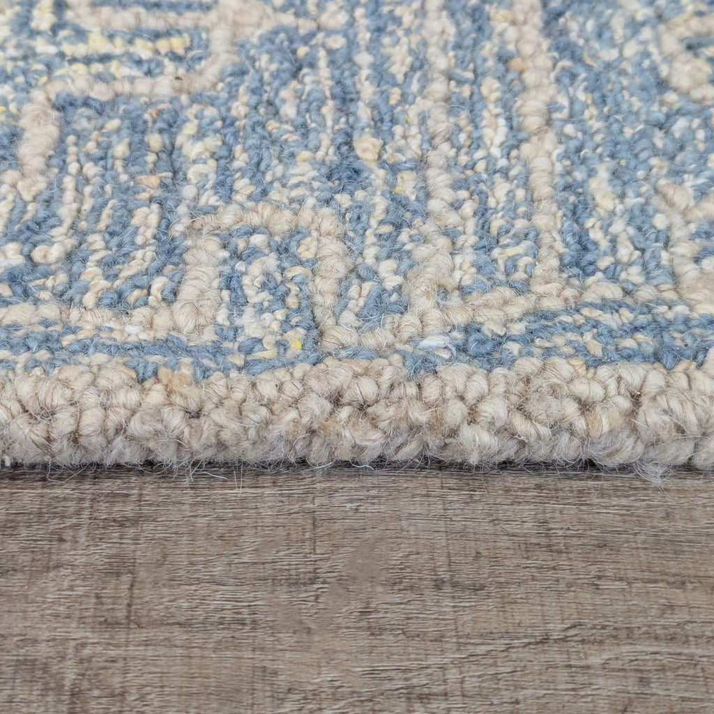 3. Side view of the Crate & Barrel rug displays its thick, soft pile and detailed hooked construction.