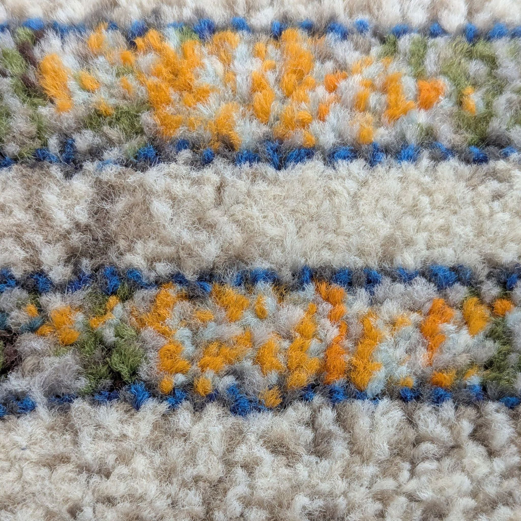 3. Detailed macro of nuLOOM polypropylene rug, highlighting textured multi-colored yarns in blue, orange, and cream.