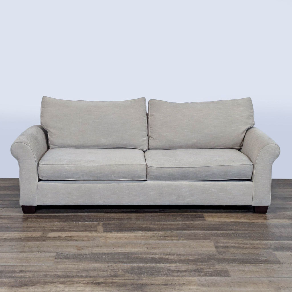 1. Pottery Barn loveseat with rolled arms, loose cushions, and removable square tapered espresso legs, front view.