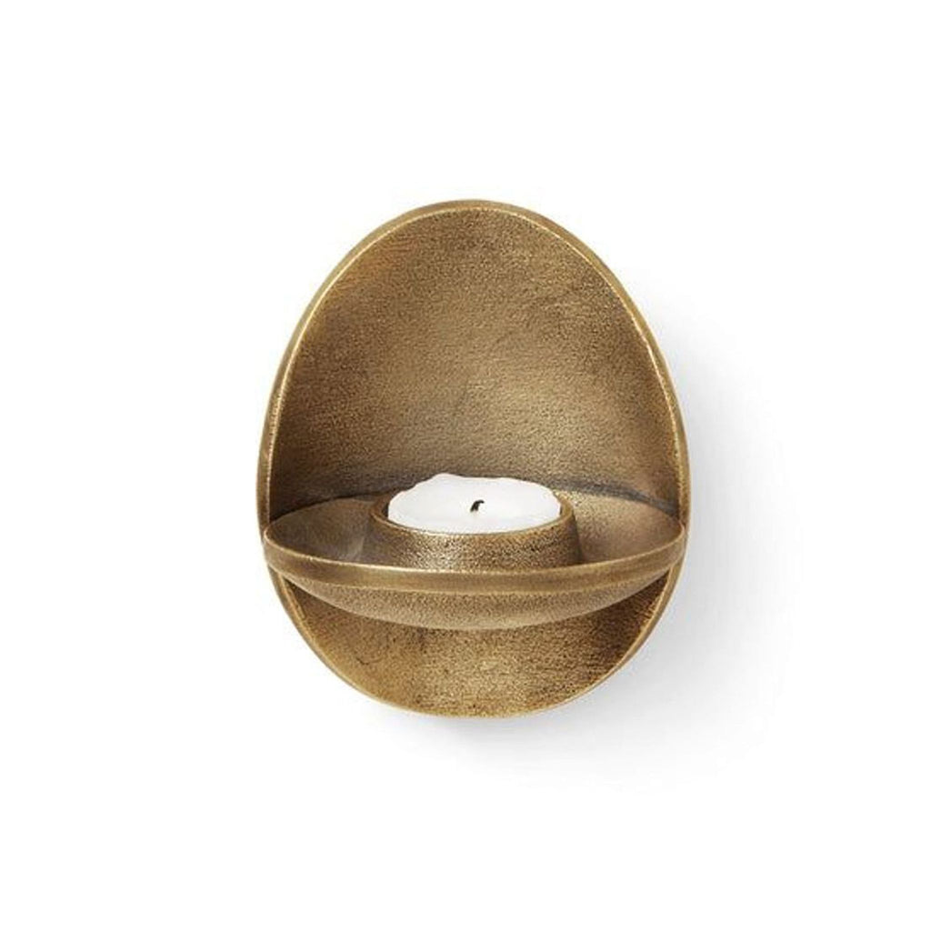 Bronze finished recycled cast aluminum tea light holder by Ferm Living, with a single white candle.  