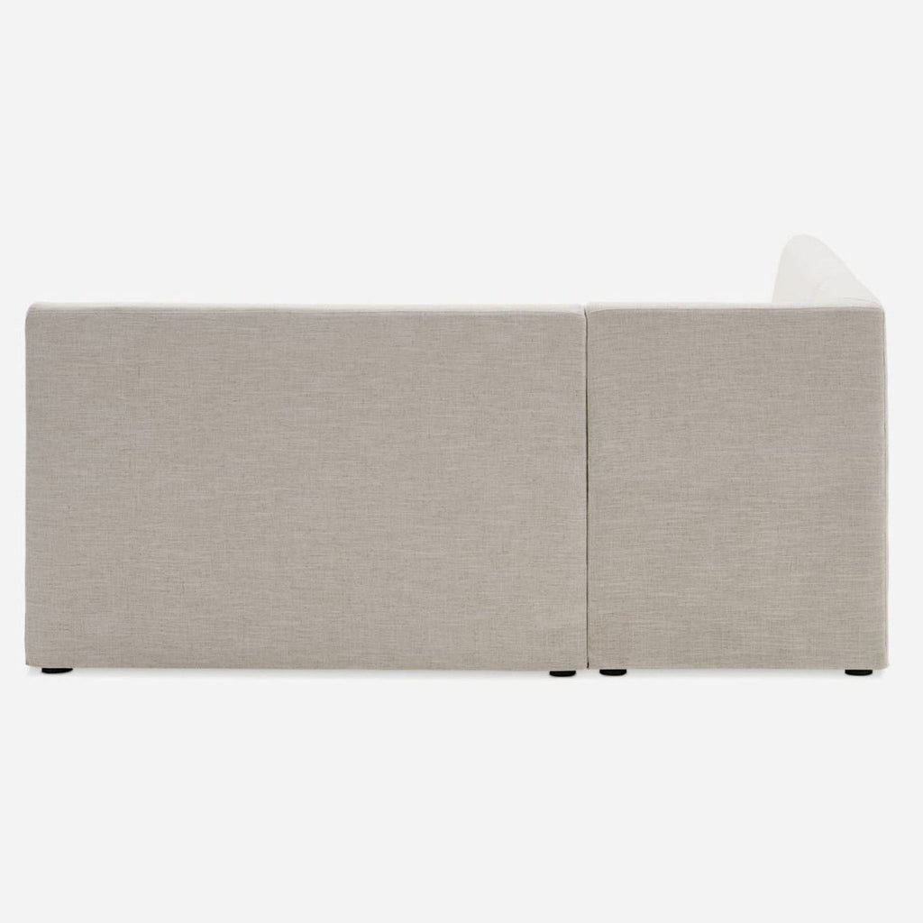 3. Back view of the Castlery sectional showing seamless beige linen upholstery and geometric modern design.