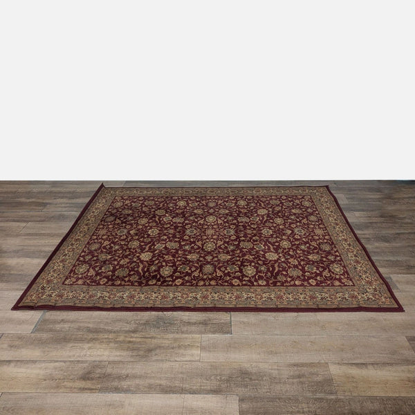 1. Burgundy area rug with an intricate floral pattern, placed on a wooden floor, from Shawh brand.