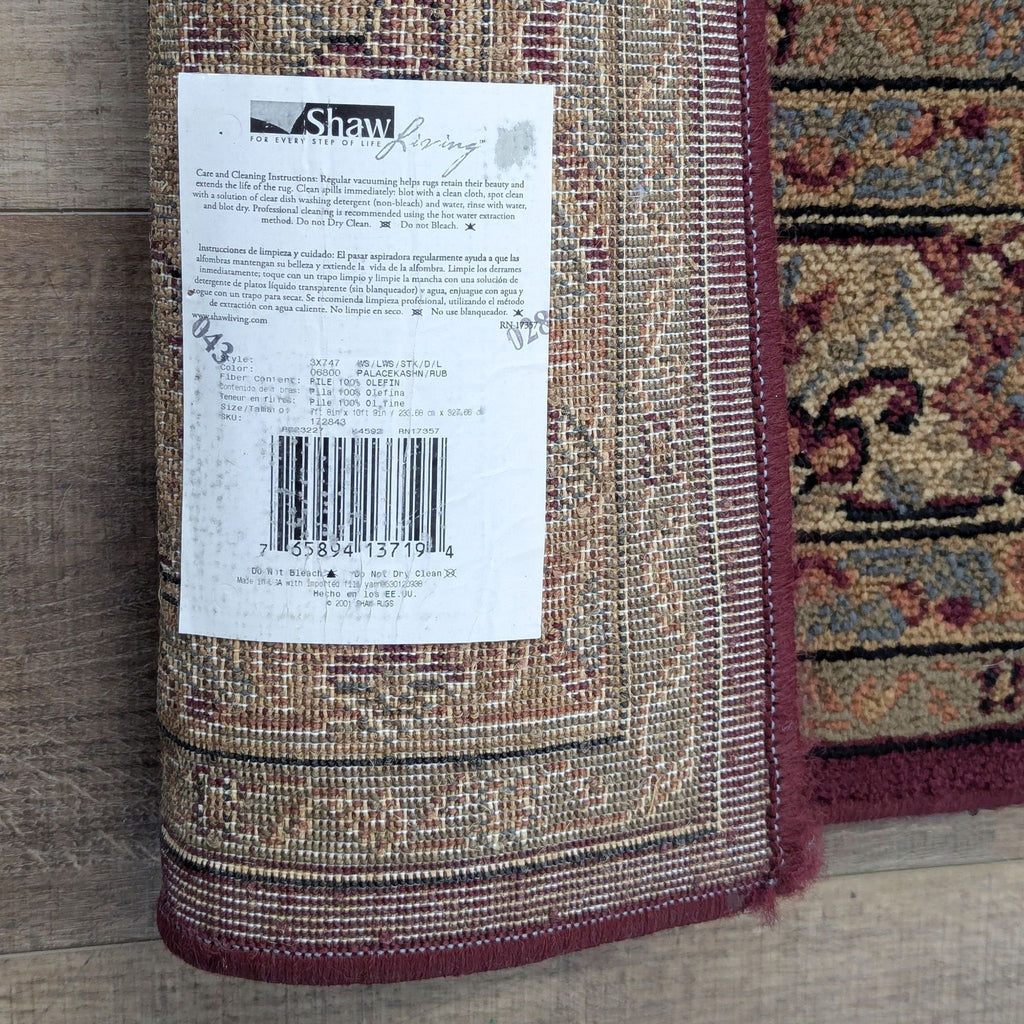 3. Shawh area rug label showing care instructions and product details, with rug’s edge visible.