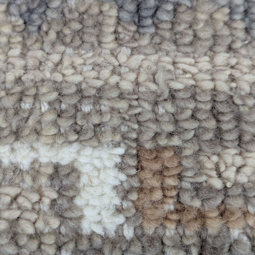 Close-up of Citizenry rug shows thick, handwoven woolen texture in beige, cream, and brown shades.  