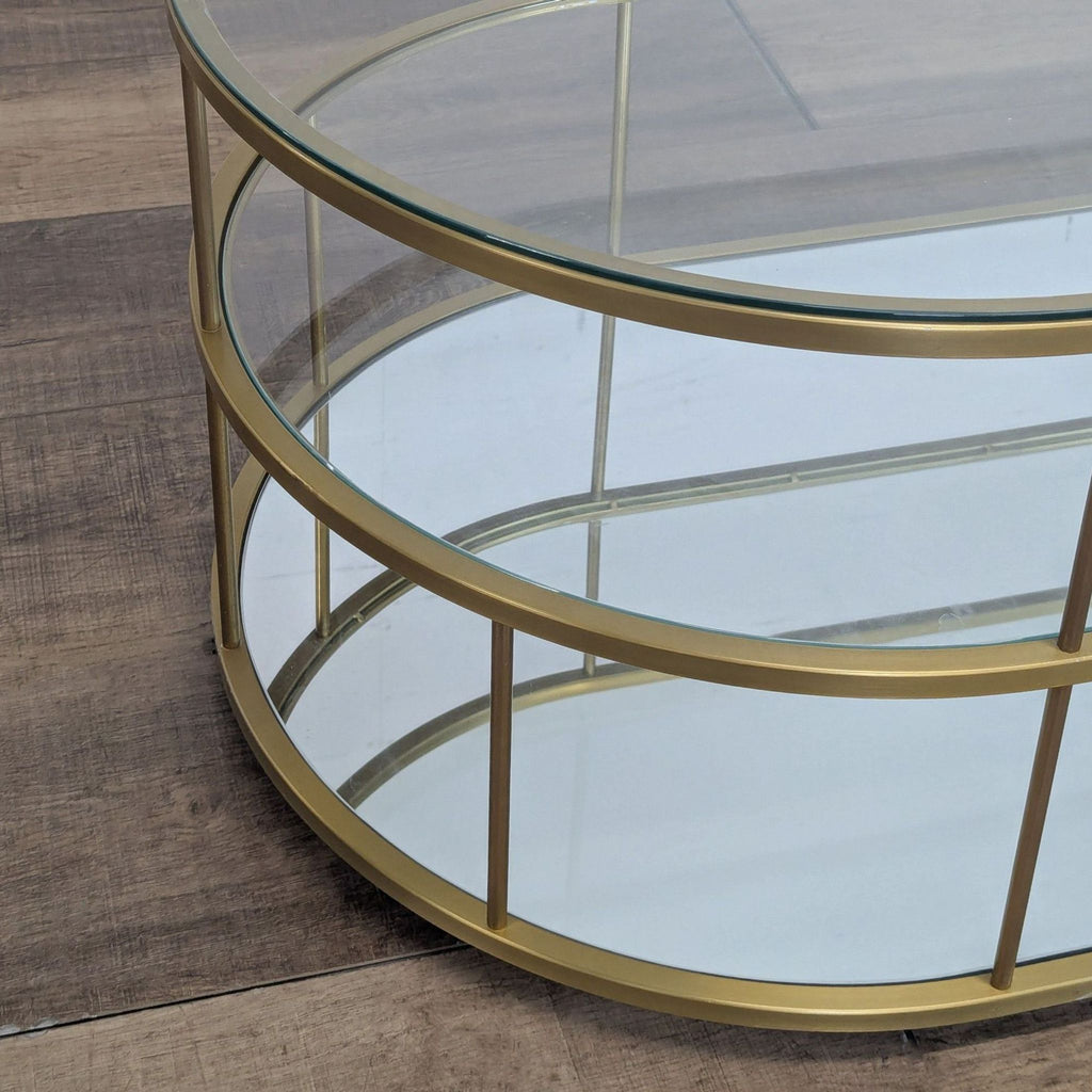 2. Close-up of the corner detail of the West Elm coffee table’s gold frame and glass shelving.  
