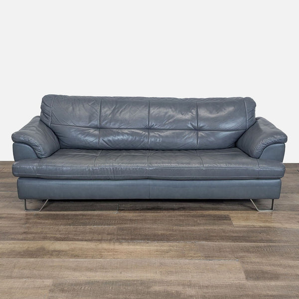 Front view of an Ashley Furniture 3-seat sofa in dark top-grain leather with tufted bench seating and metal feet.  