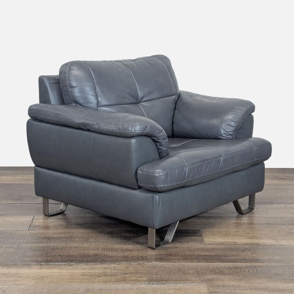 3. Angled view of Ashley Furniture lounge chair in gray leather with tufted stitching, plush arms, and sturdy metal base.
