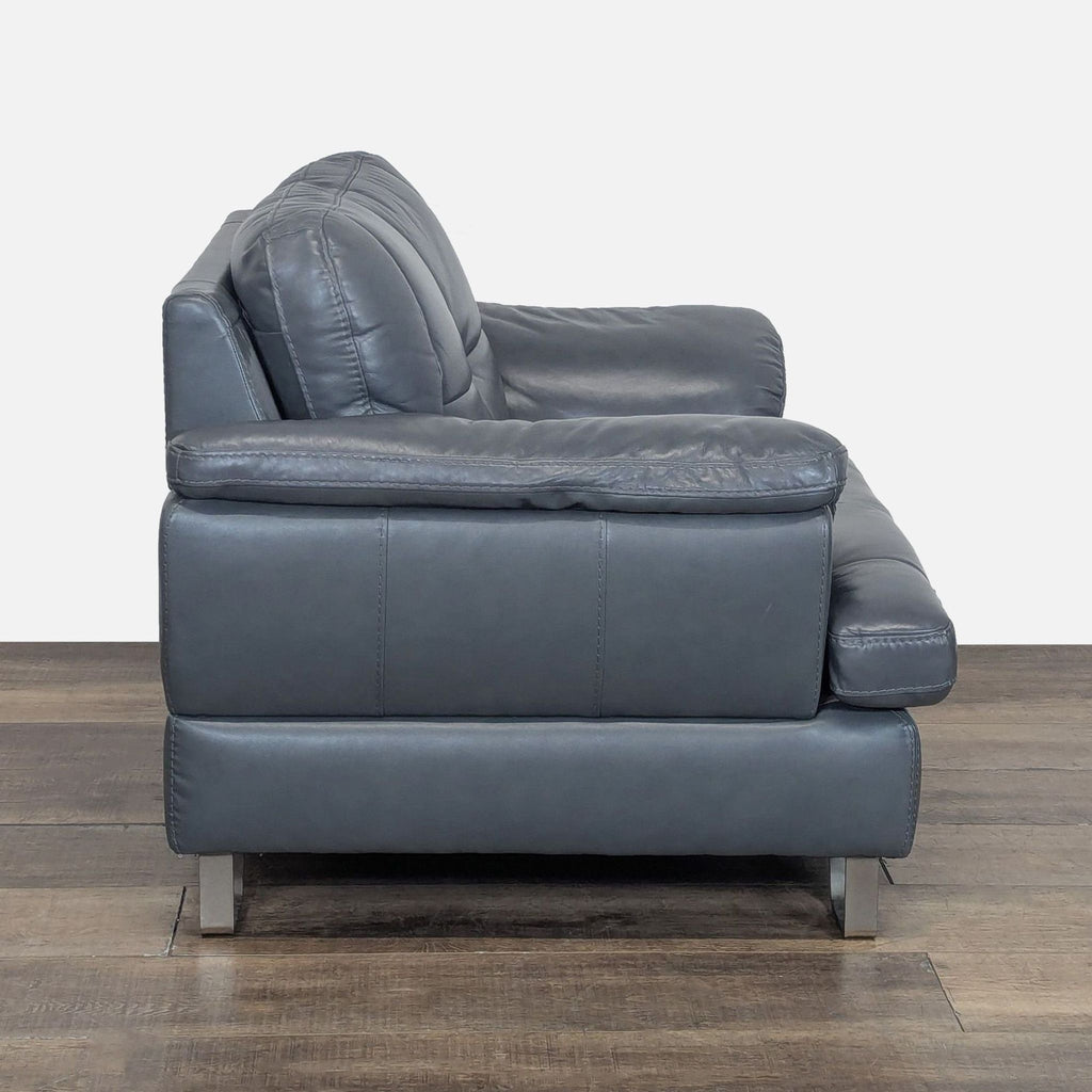 2. Side view of Ashley Furniture lounge chair, featuring stitched top-grain leather and DuraBlend cushions on metal feet.