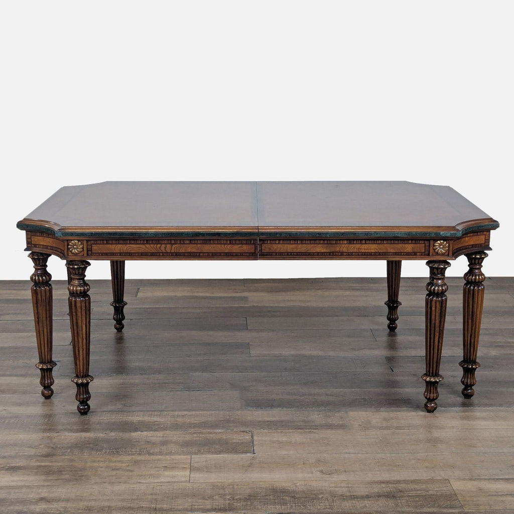 2. Glossy dark wood dining table by Reperch with carved apron and turned legs, extended with two leaves.