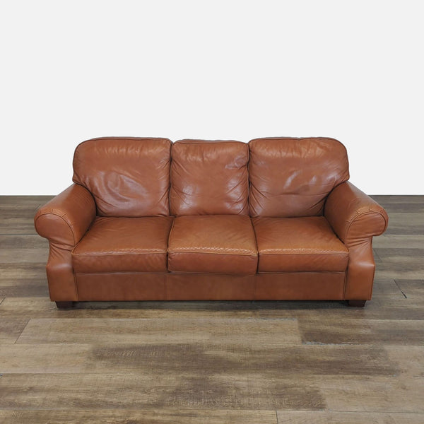 Brown genuine leather Moran 3-seat sofa with rolled arms and wood block feet, shown from the front.