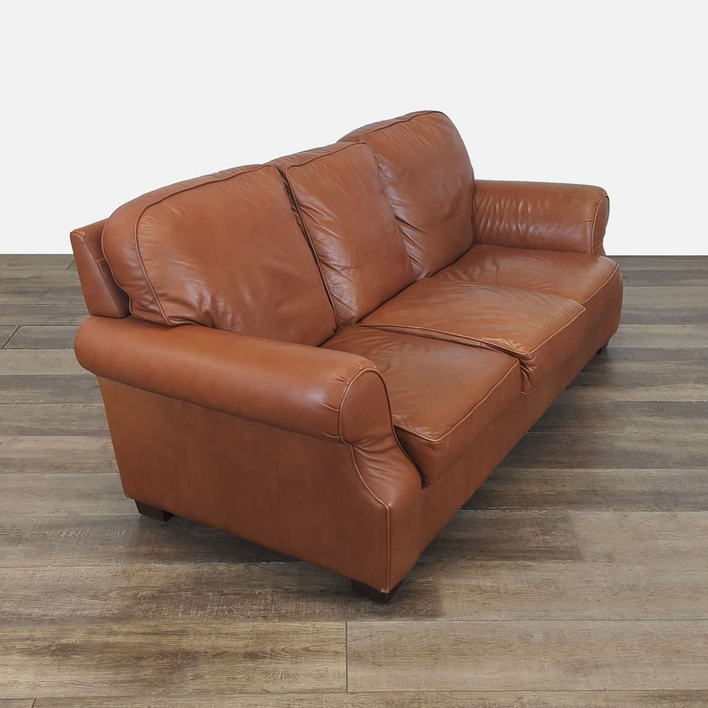 Side view of a Moran 3-seat sofa with genuine leather upholstery, rolled arms, and tapered wooden feet.