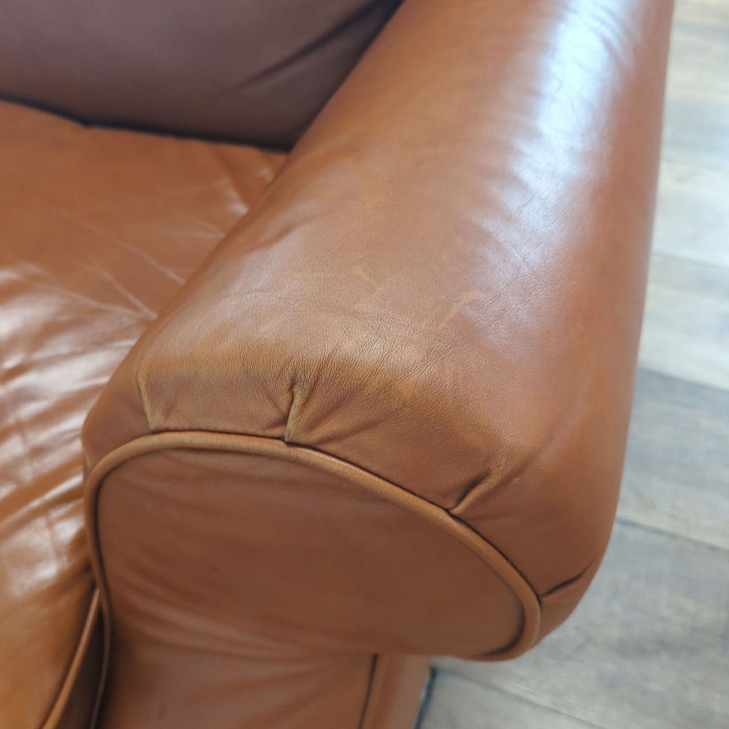 Close-up of a rolled armrest on the Moran 3-seat sofa, highlighting genuine leather texture.