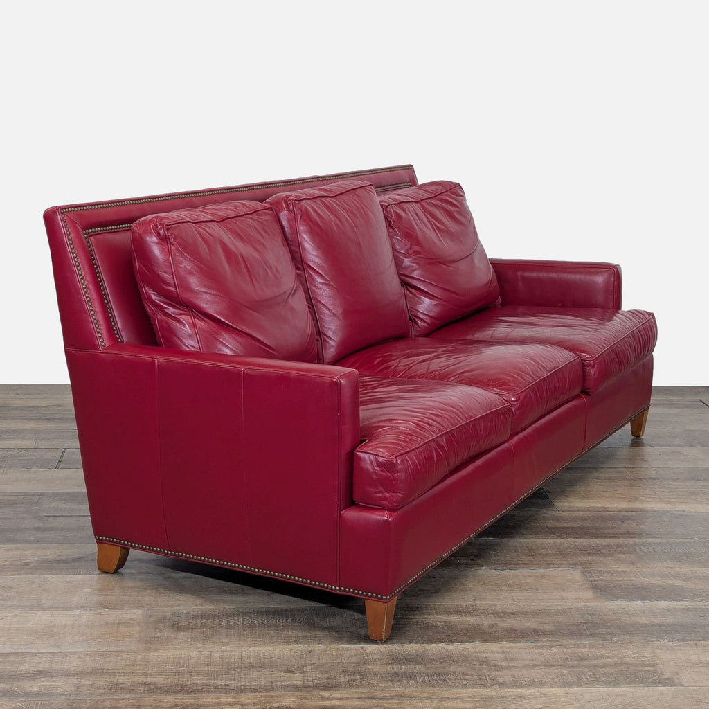 3. Angled view of the Hancock & Moore 3-seat sofa, featuring loose backs, nailhead trim, and tapered wooden feet.