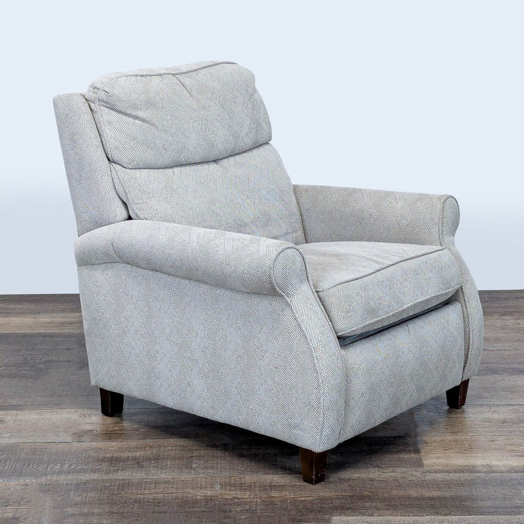 3. Angled view of a Comfort Design lounge chair featuring rolled arms, tapered wood feet, and elegant patterned fabric.