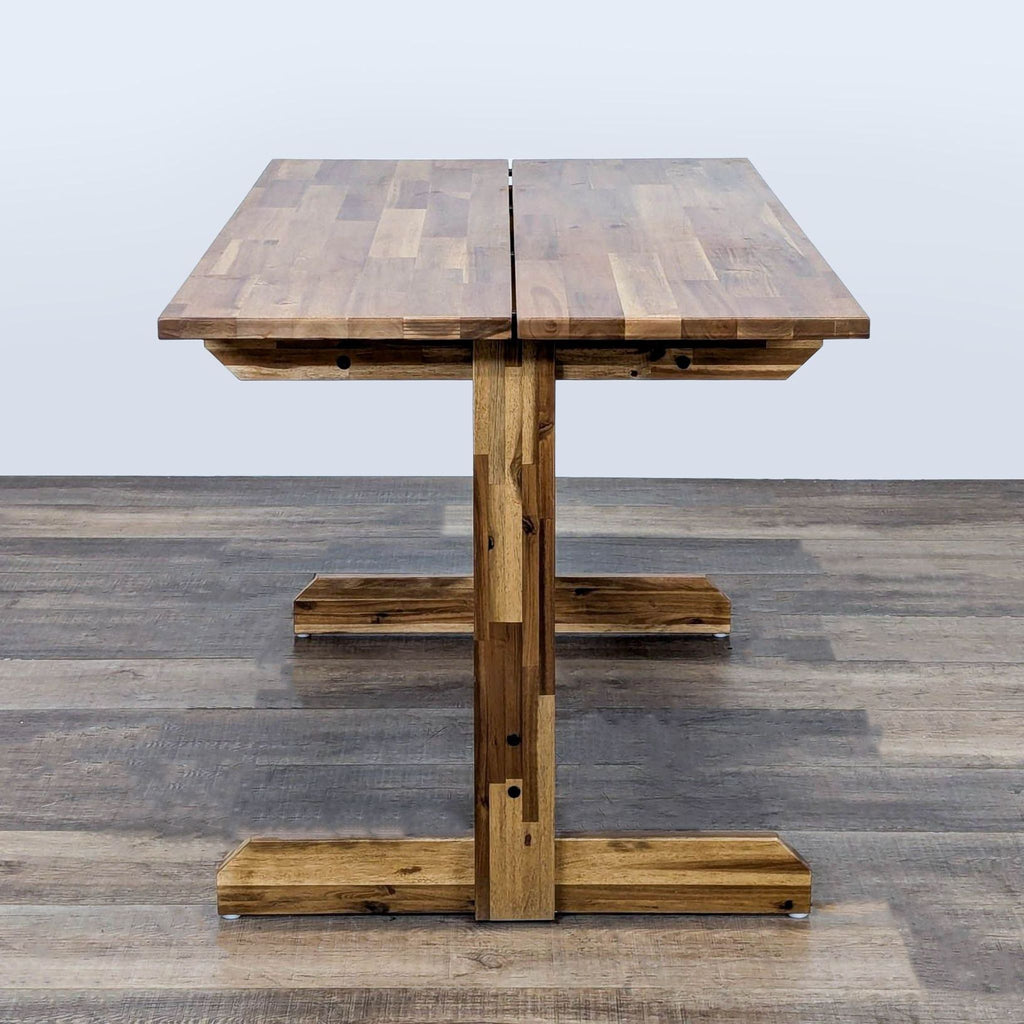 3. IKEA dining table made of solid acacia wood, designed with central support legs, suitable for versatile seating arrangements.