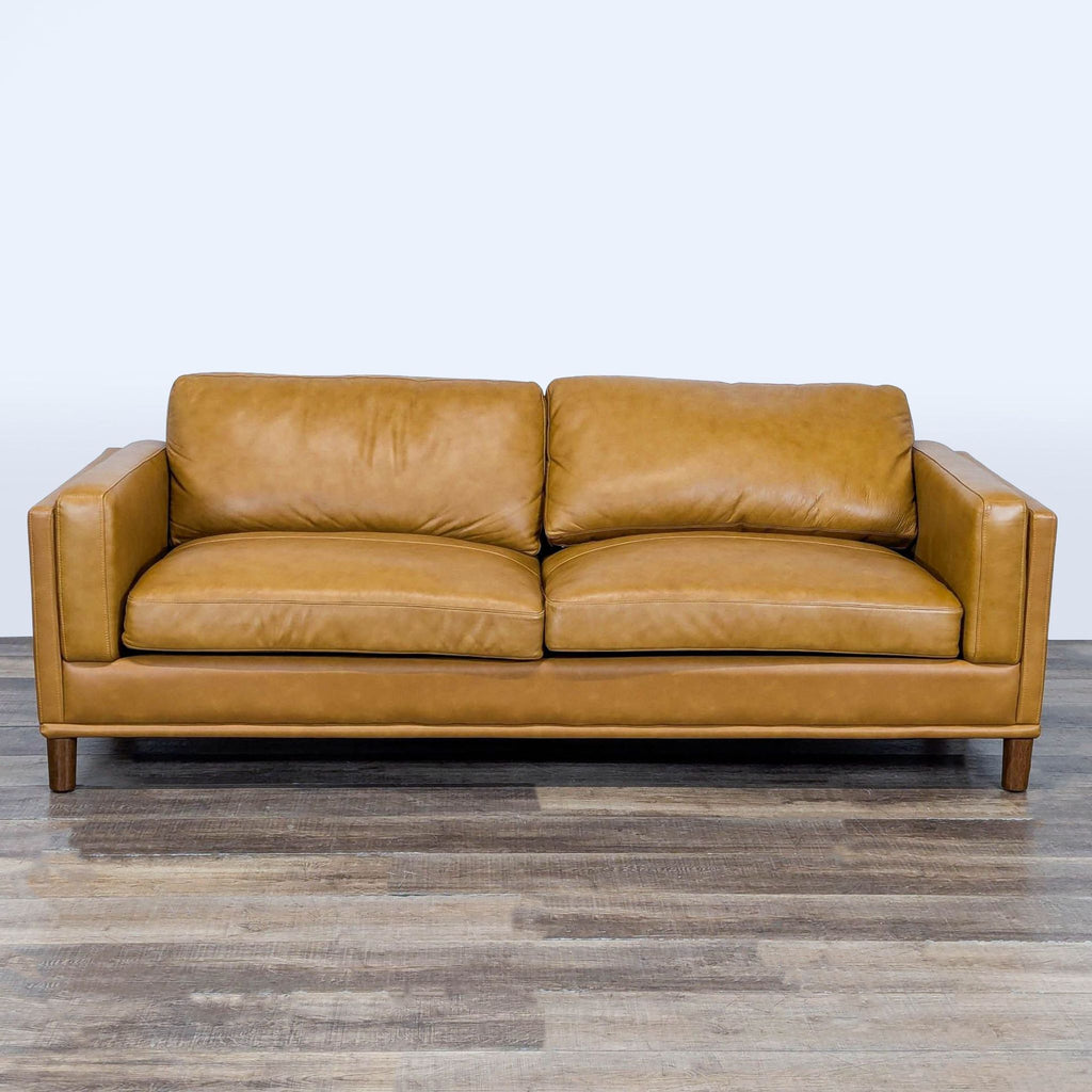 1. Front view of a Wade Logan 3-seat leather sofa with detailed stitching, wood legs, and track arms.