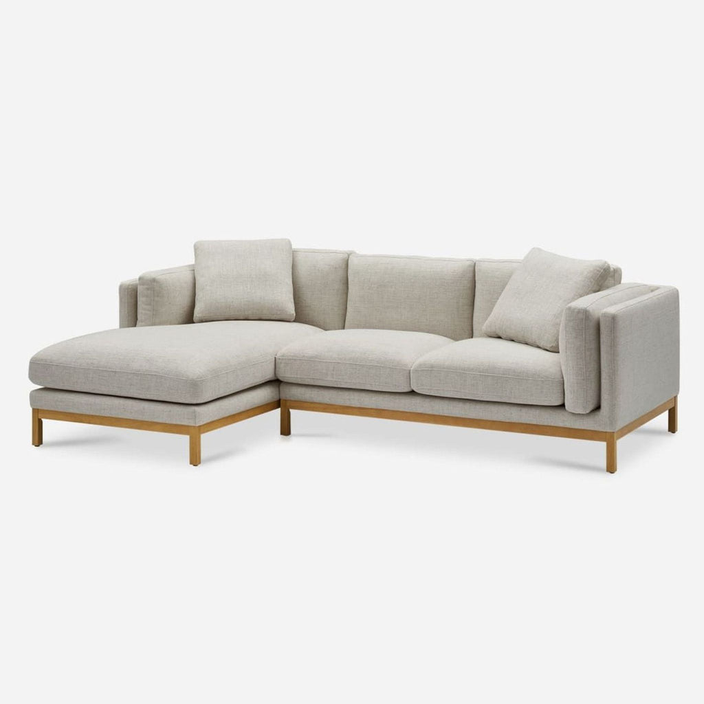 3. Angled view of the Castlery sectional sofa with plush cushions, wood frame, and right chaise lounge.