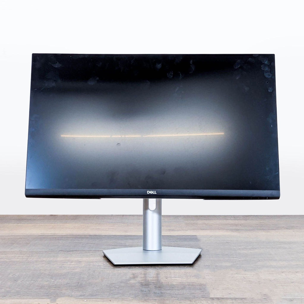 Front view of the Dell S2722QC 27-inch 4K UHD monitor with ultra-thin bezels on a wooden desk.