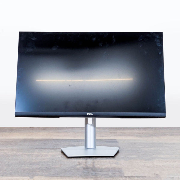 Front view of the Dell S2722QC 27-inch 4K UHD monitor with ultra-thin bezels on a wooden desk.