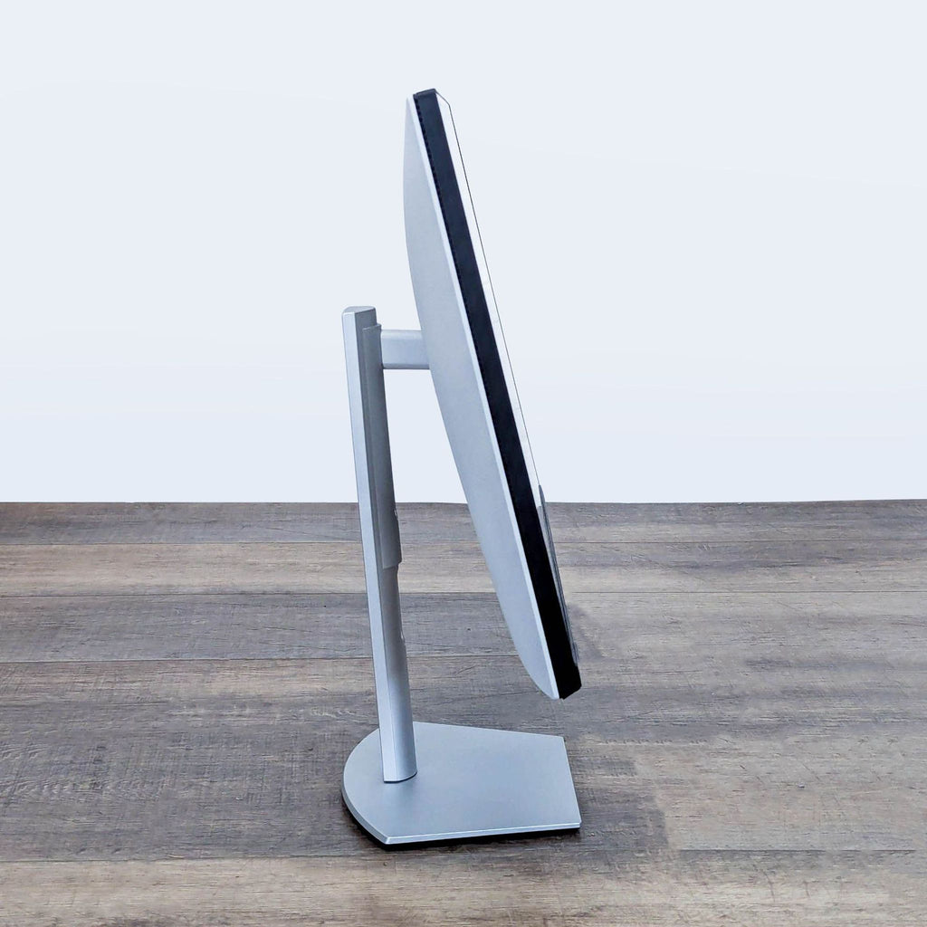 Side profile of the Dell S2722QC 27-inch monitor, highlighting its slim, adjustable stand and sleek design.