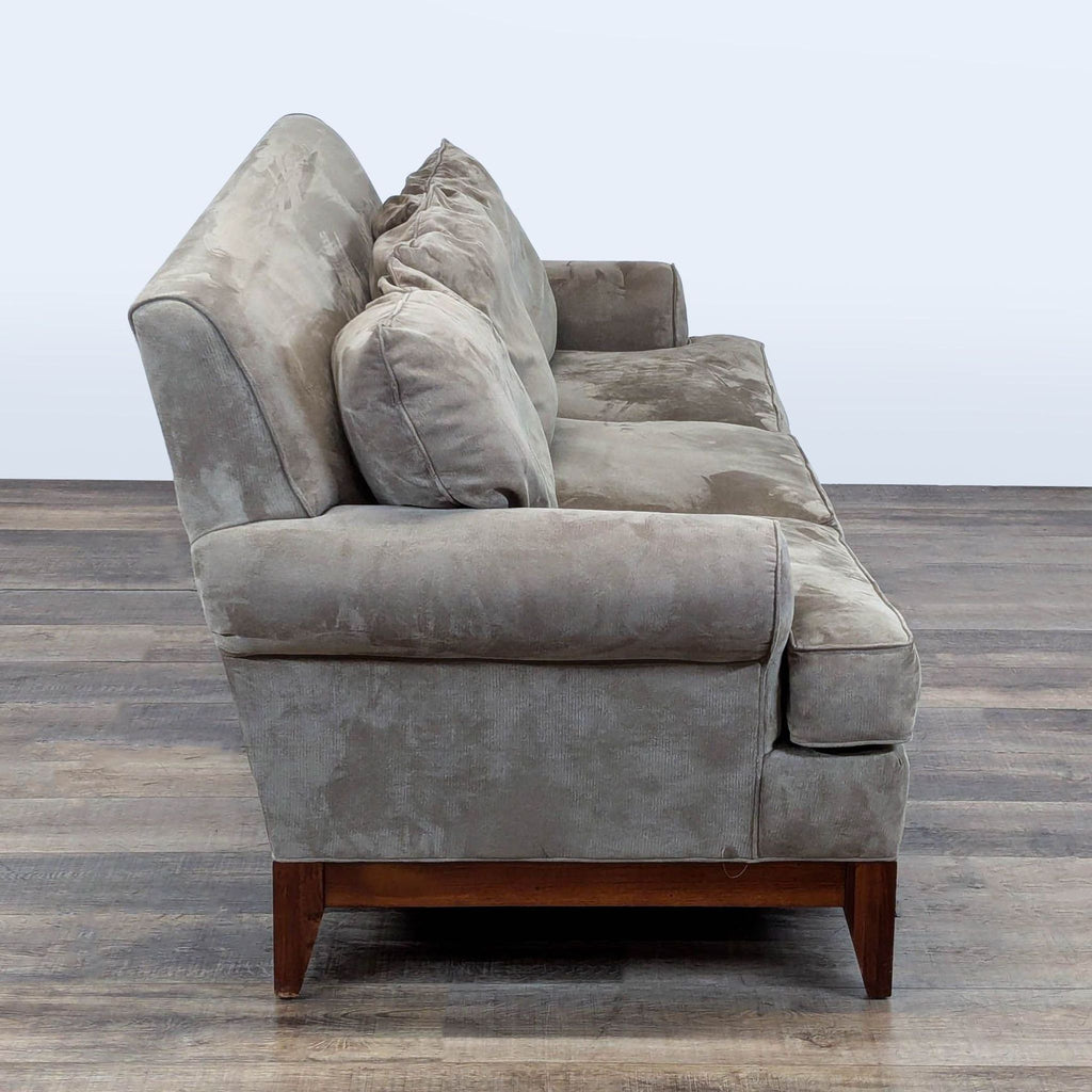 2. Side view of a Kincaid Furniture 3-seat sofa with plush cushions, rolled arm, and wooden base.