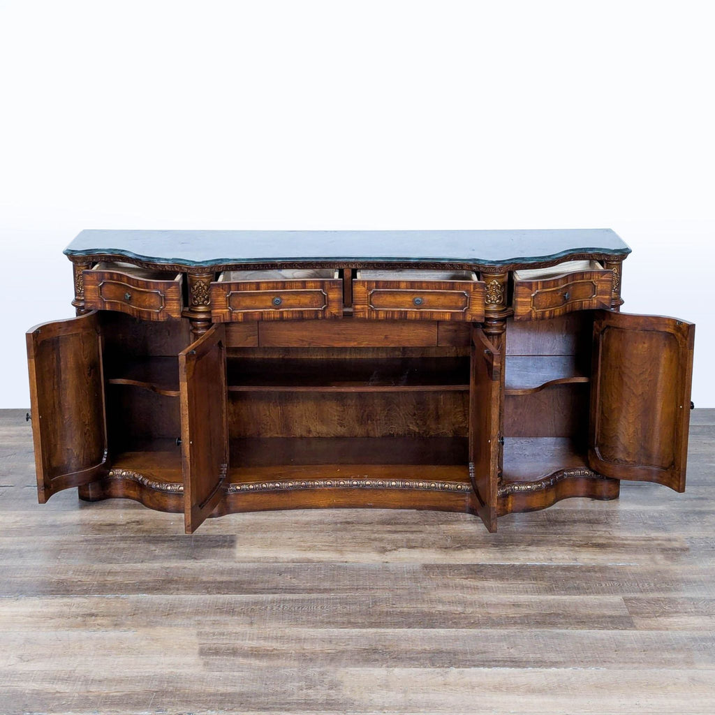 2. Interior view of a gilded, carved wood buffet sideboard by Orleans International, showing spacious cabinet storage.