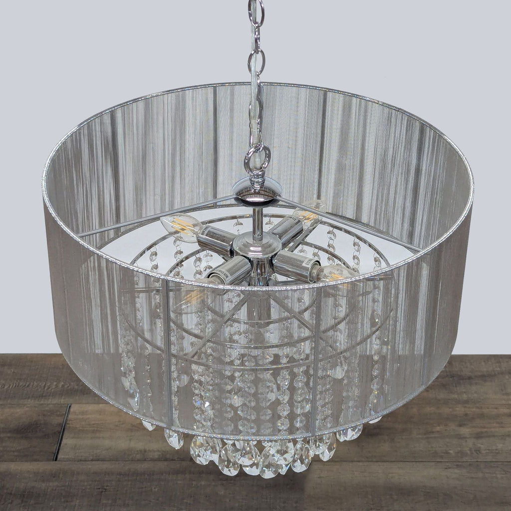 2. Overhead view of a Reperch lighting fixture with chrome finish, sheer metallic shade, and crystal prisms.  