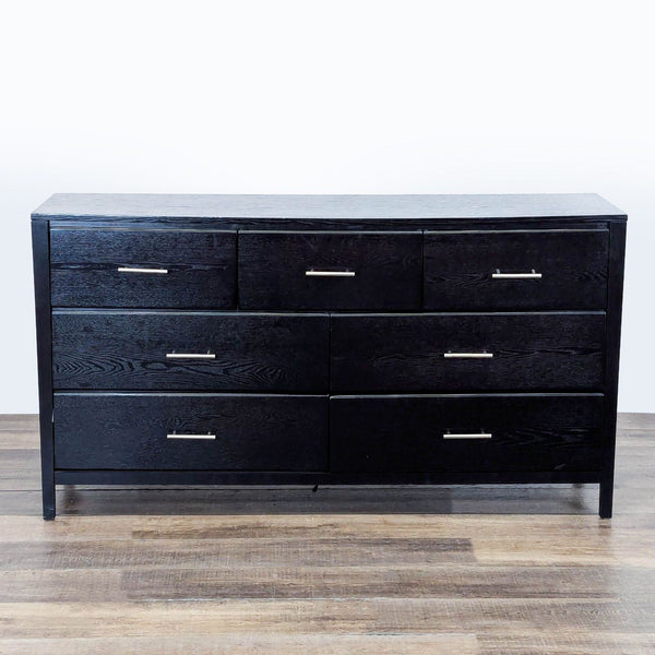 1. Black dresser with 7 drawers and brushed nickel bar handles by New Classic Furniture, front view.