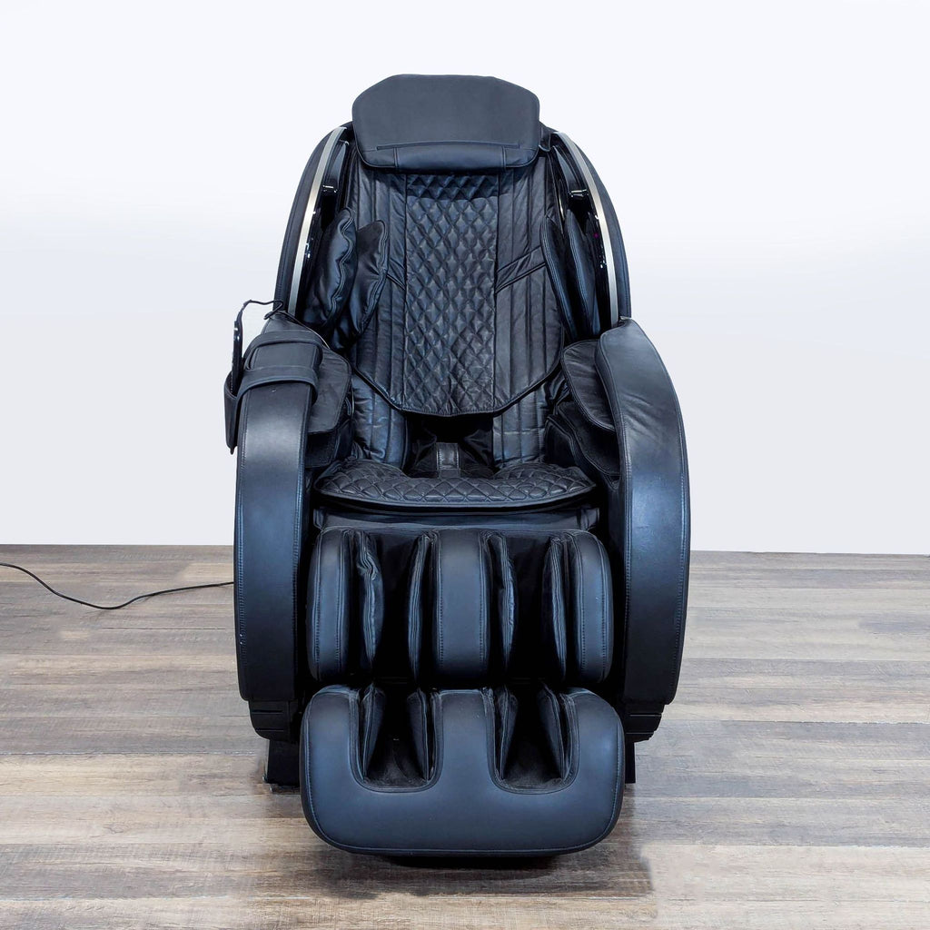 1. Front view of a black Massage Medik zero gravity massage chair with padded seating and elevated leg rests.