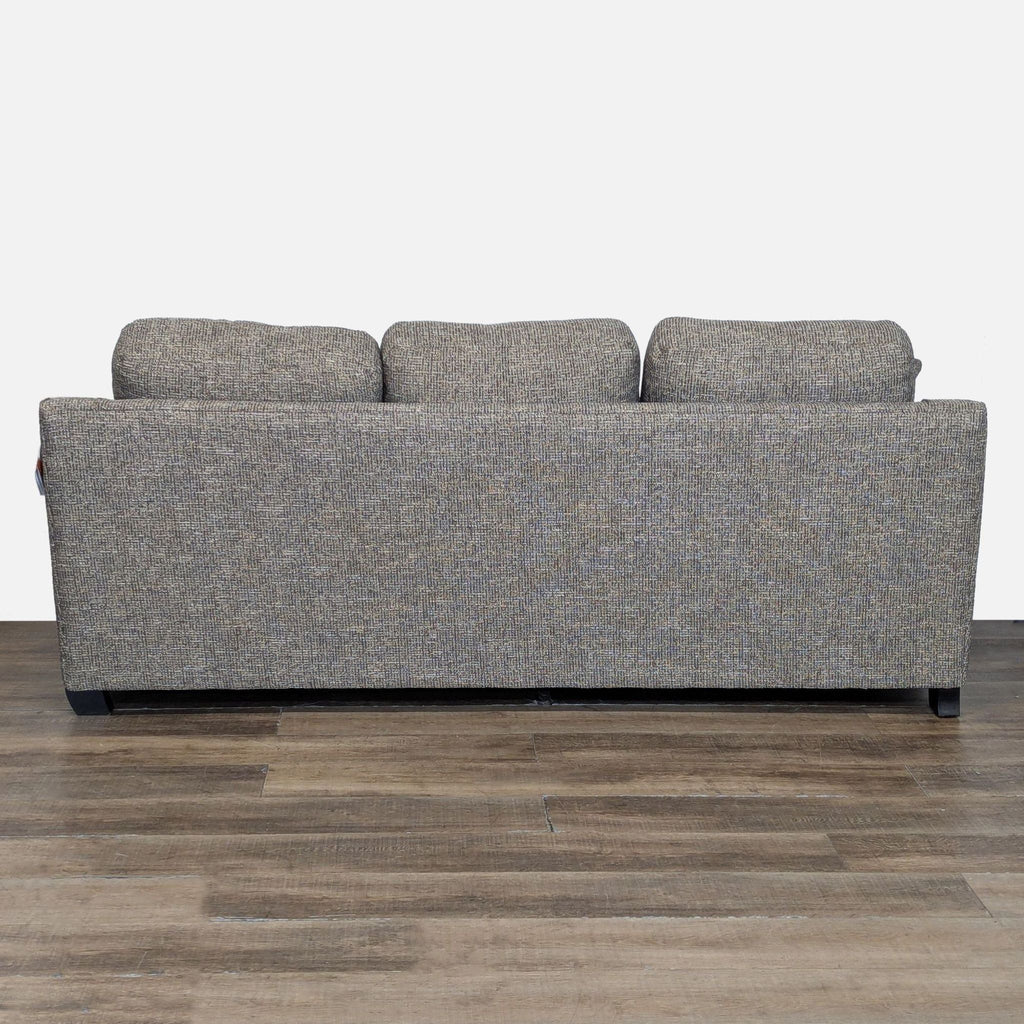 3. Back view of La-Z-Boy 3-seat sofa displaying its textured fabric and solid wood block feet.