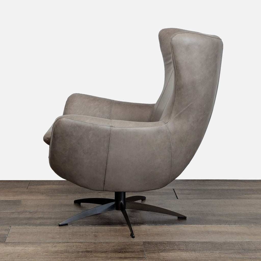 2. Side profile of a Pottery Barn lounge chair with curved top-grain leather and bronze swivel base.  