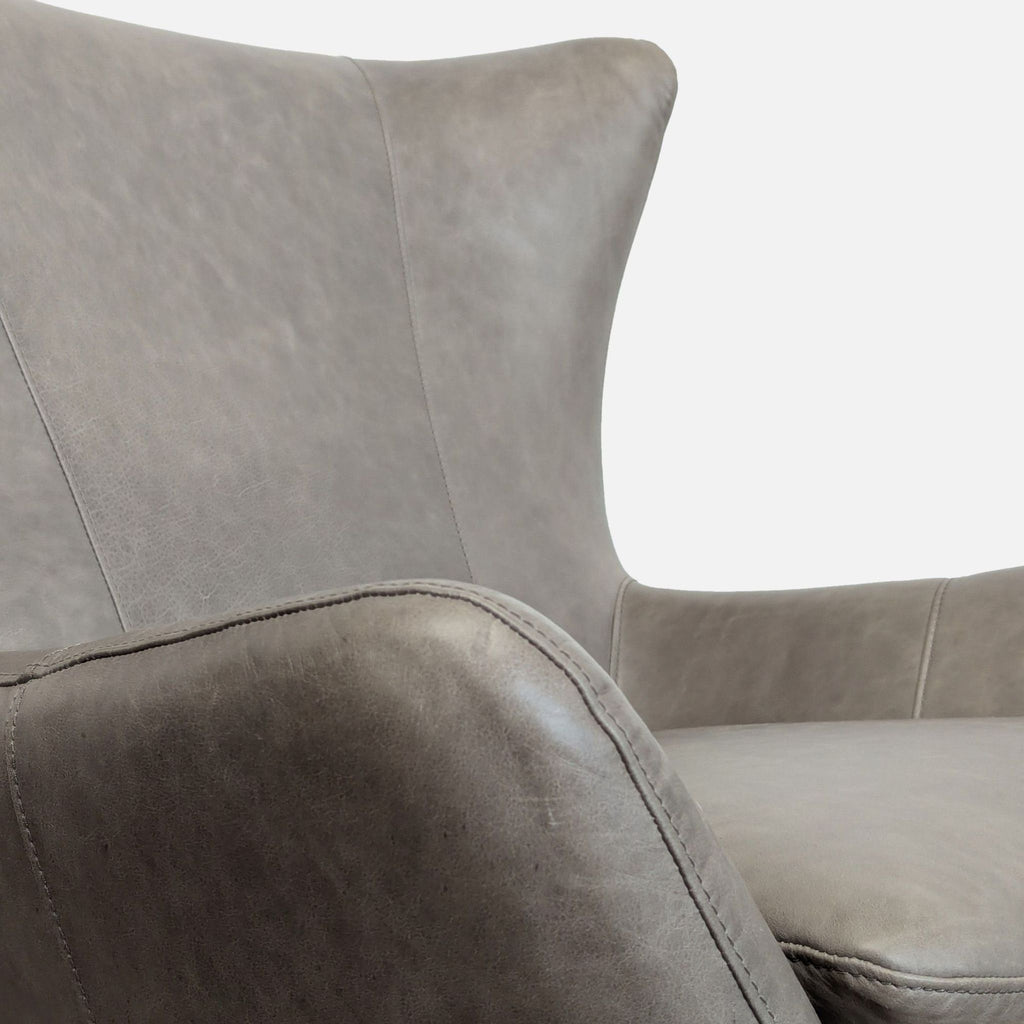 3. Close-up of semi-aniline dyed leather upholstery and stitching on Pottery Barn lounge chair.