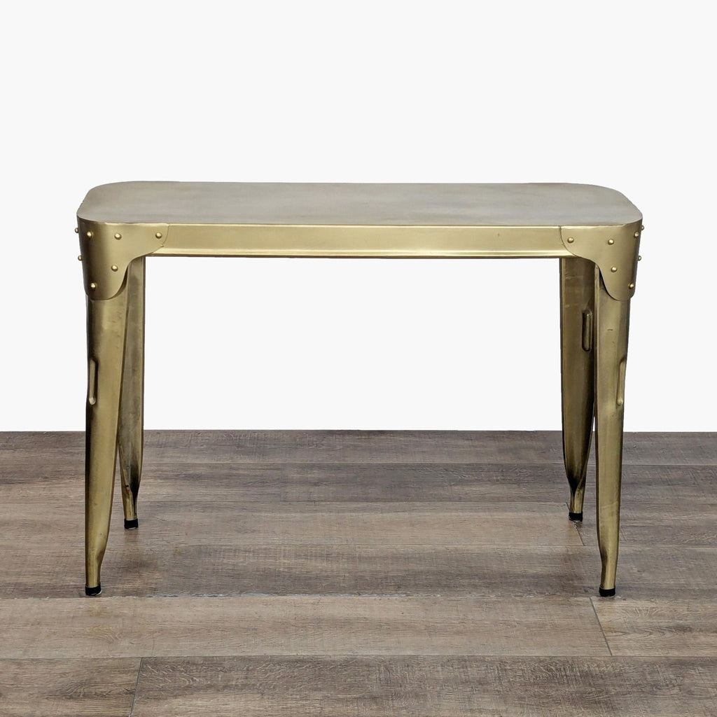 Metal console table by Rosdorf Park with riveted corner patches, shown on a wood floor.  
