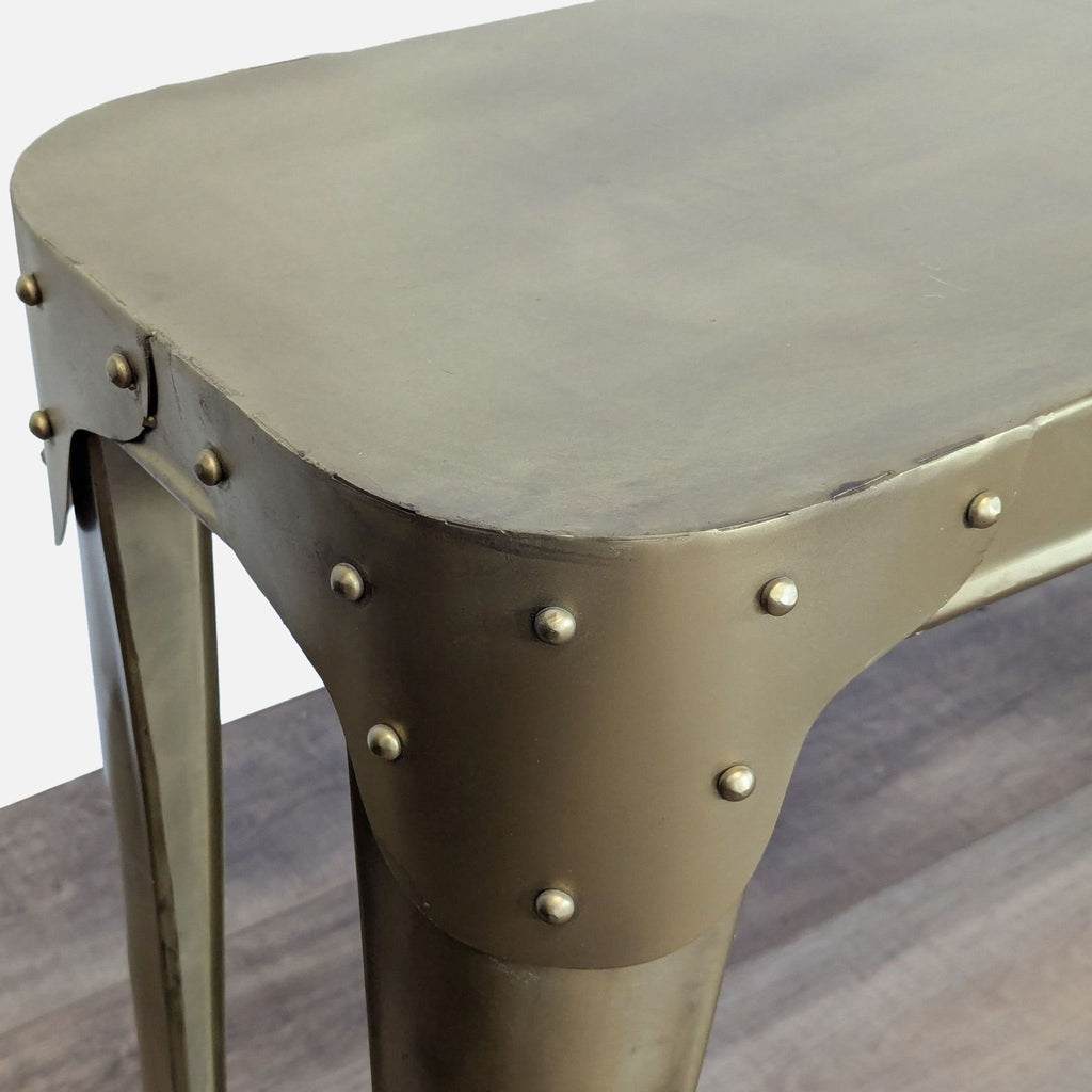 Close-up of the Rosdorf Park metal console table’s riveted corner detail and brushed finish.  