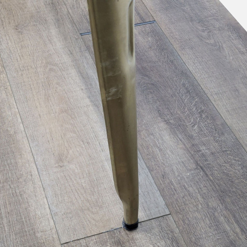 Detailed view of the tapered metal leg on the Rosdorf Park console table, highlighting artisan craftsmanship.