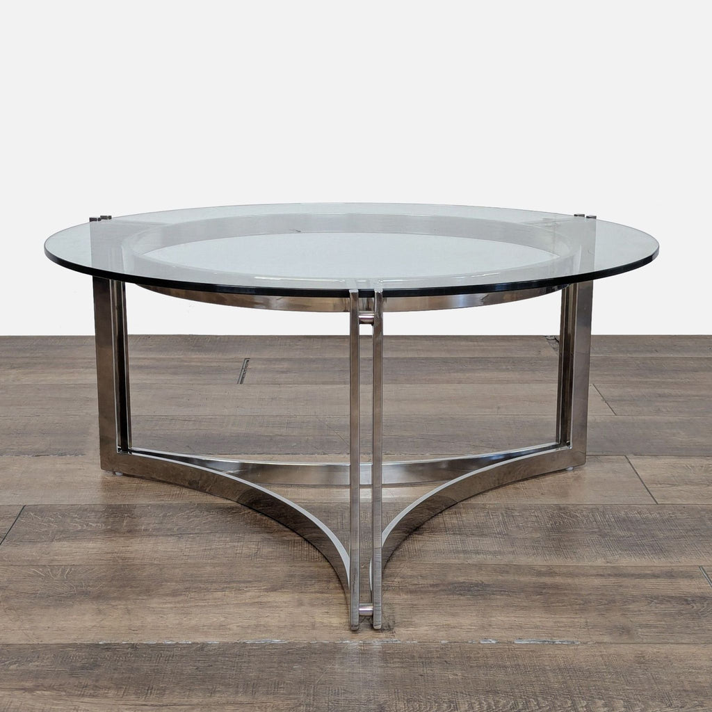 1. Reperch Chrome base coffee table with a round glass top and sleek metal frame, front view.  