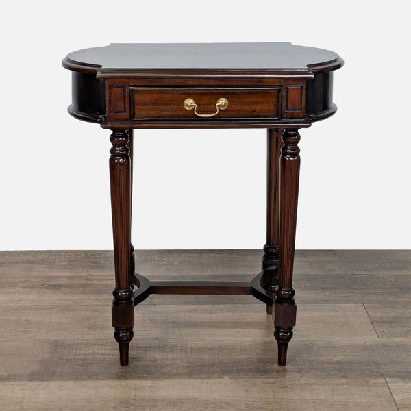 1. Dutch Crafters end table with solid wood, fluted legs, trestle base, and mahogany finish, drawer closed.