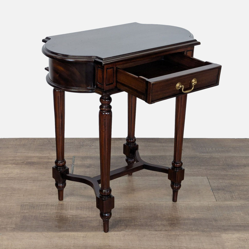 2. Mahogany-finished Dutch Crafters end table with fluted legs and trestle base, shown with drawer open.