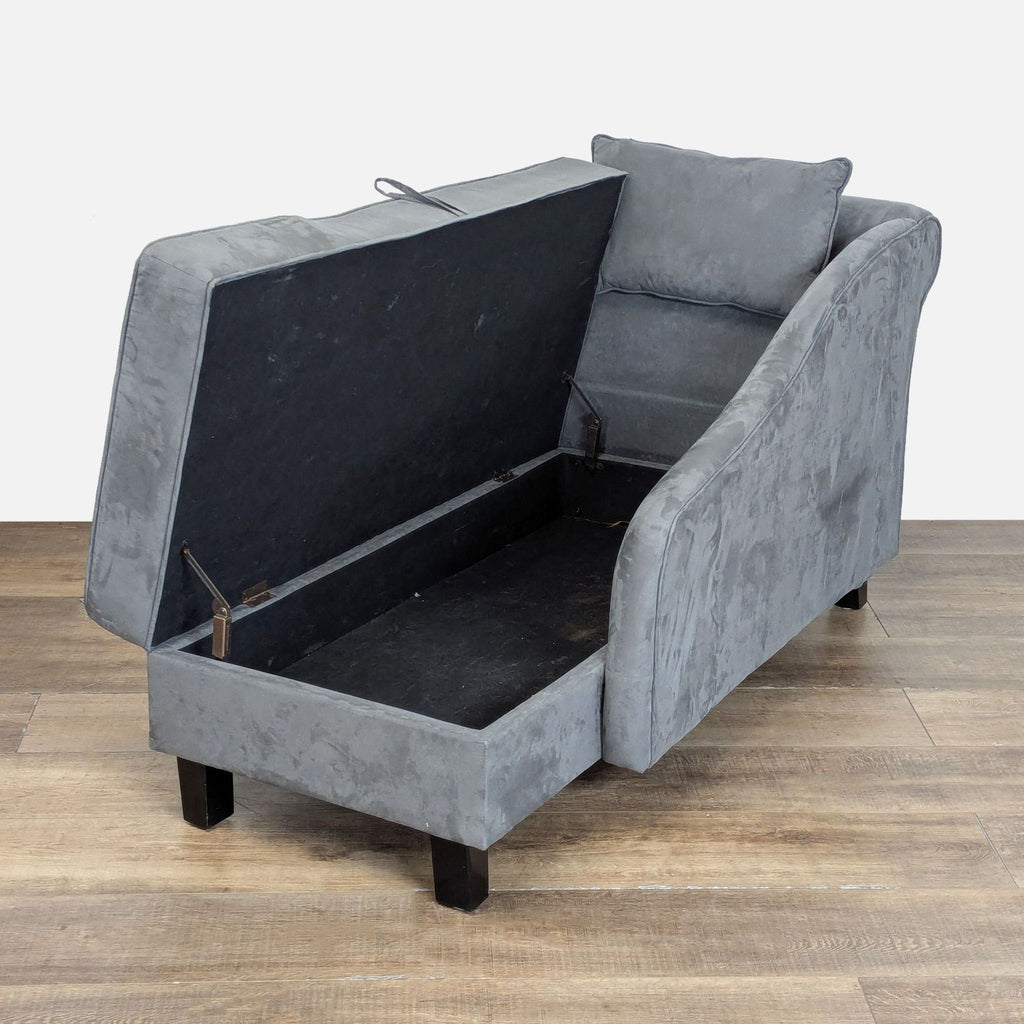 Grey upholstered Reperch chaise with open storage compartment and wood legs, displaying interior space.  