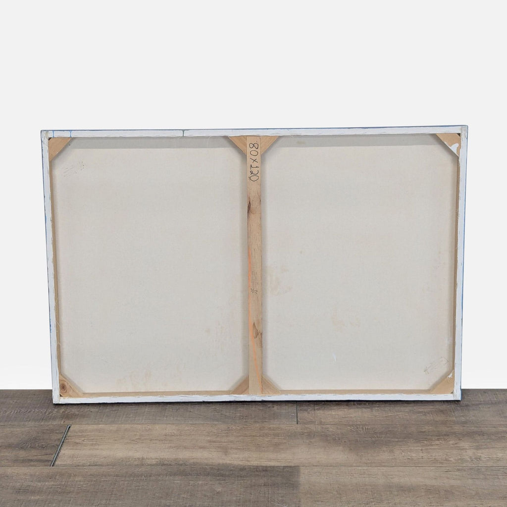 3. Back view of the canvas artwork by Reperch, revealing its wooden frame and blank surface.