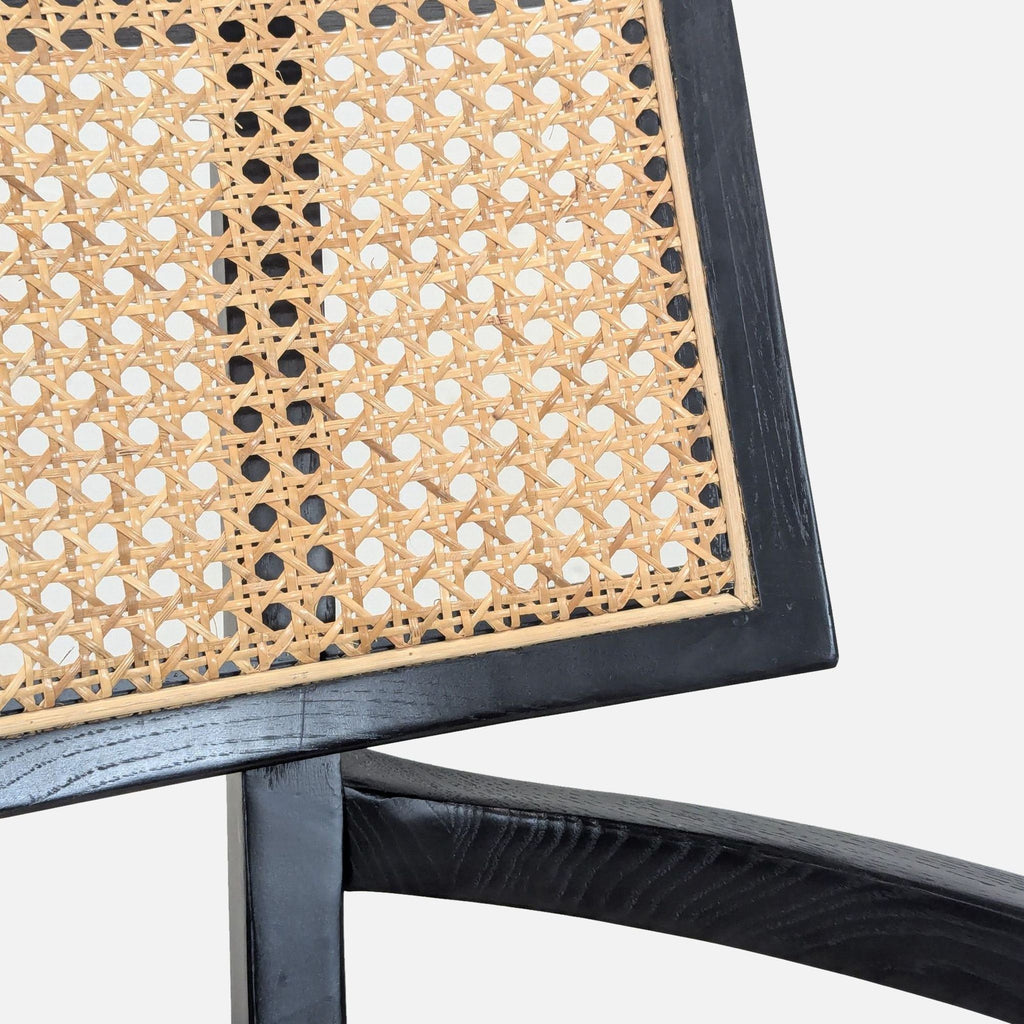 3. Close-up of the woven cane backrest and black nettlewood frame detail on the Crate & Barrel Libby chair.