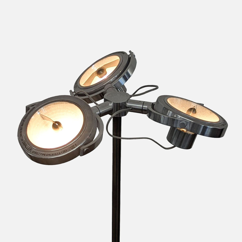 2. Close-up of three dimmable, articulated chrome spotlights on an Ikea lamp, showing detailed metal finish.  