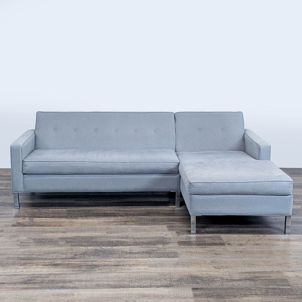 1. Modern L-shaped Reperch sectional sofa with light gray upholstery, button-tufted back, and metal legs, front view.
