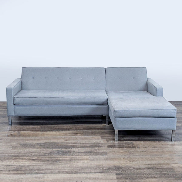 1. Modern L-shaped Reperch sectional sofa with light gray upholstery, button-tufted back, and metal legs, front view.