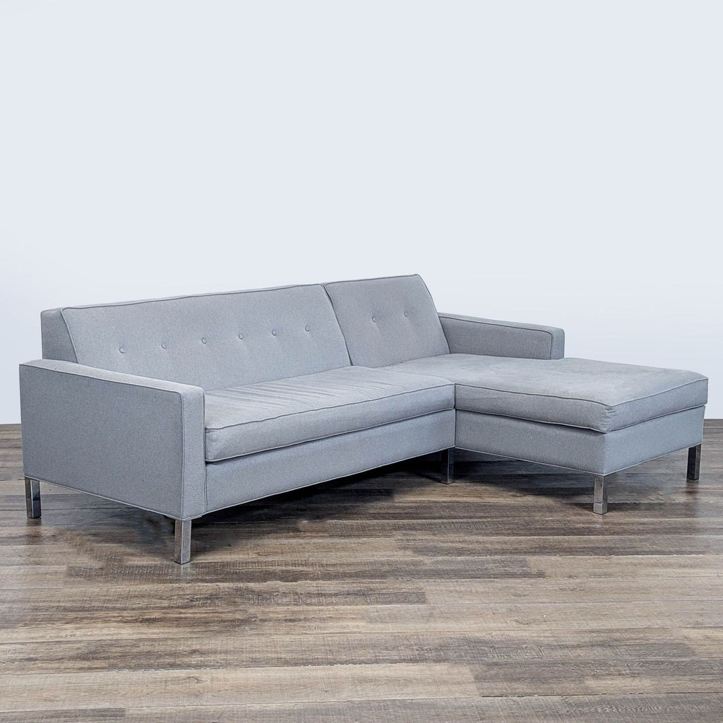 3. Angled view of a Reperch sectional, light gray upholstery with tufted cushions and metal legs, category: Sectional.