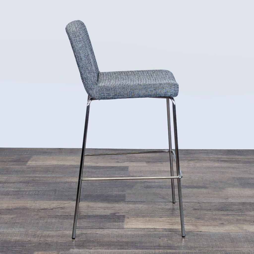 3. Profile view of the CB2 stool from the Stools, Ottomans & Benches category, showing padded seat and back.